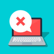 speech bubble with cross on laptop
