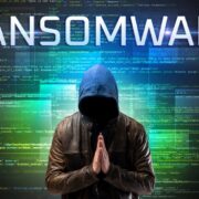 man with hood praying with ransomware word on top of him