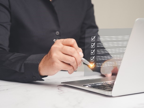 Man works on laptop on password policy strategy